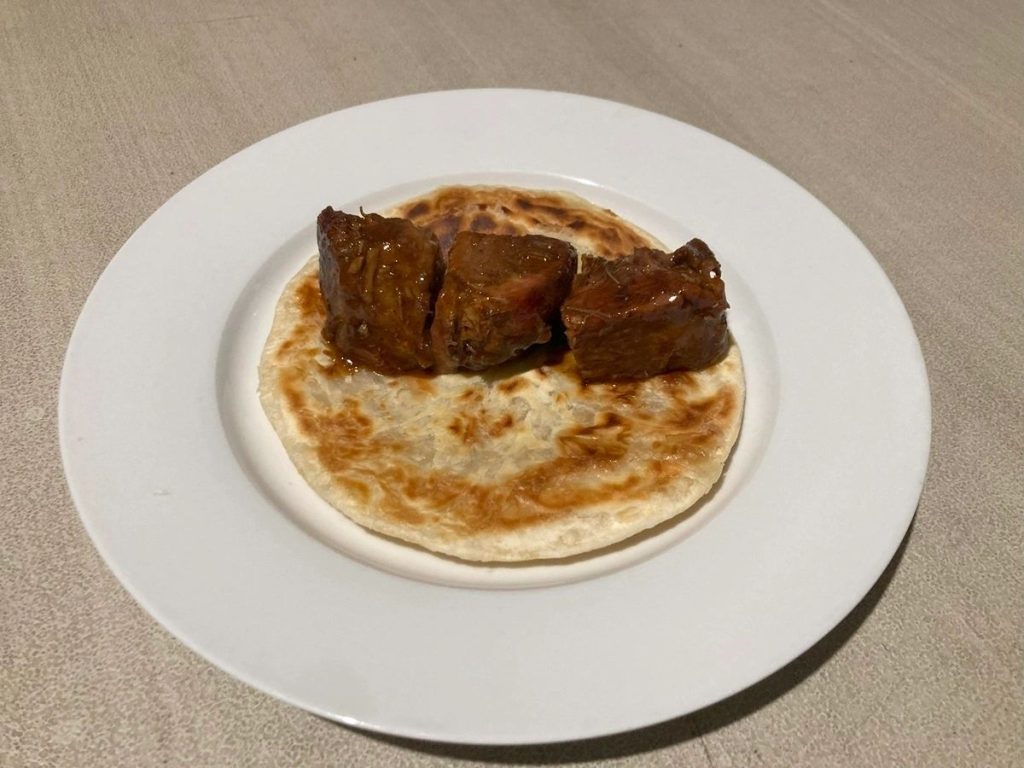Serve Burnt Ends Pork squares on Paratha bread